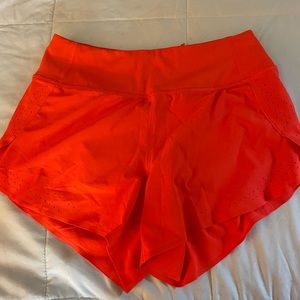 Allyson Felix Athleta collab shorts, bright orange